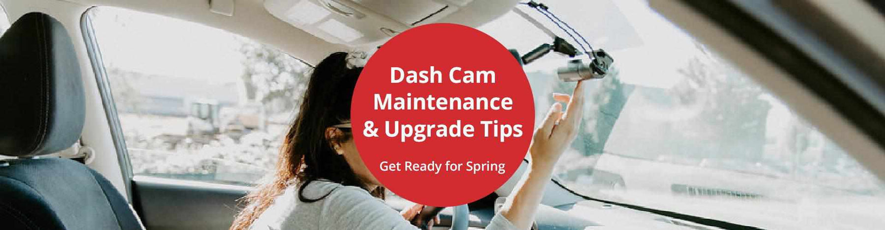 Driver performing seasonal dash cam maintenance