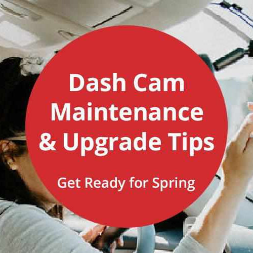 Driver performing seasonal dash cam maintenance