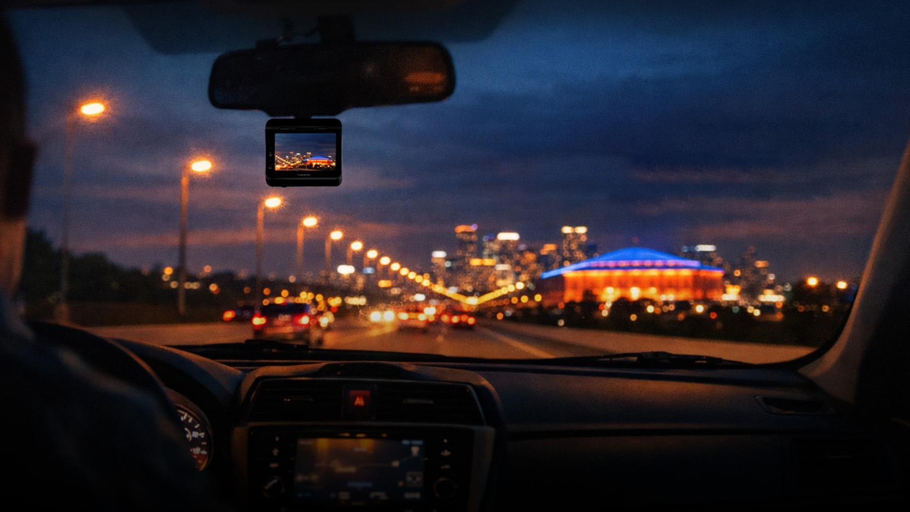 Night road trip toward a busy playoff venue with a dash cam installed