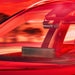 BlackVue front camera mounted behind a windshield in warm red light