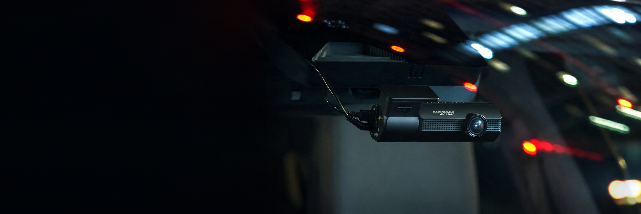 BlackVue dash cam mounted on a windshield during a night drive
